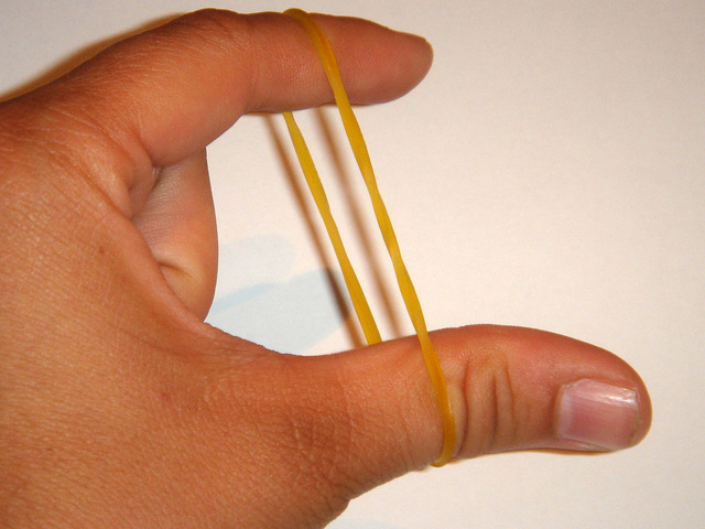 When rubber band is pulled with an external force. It changes its length and cross section area.
