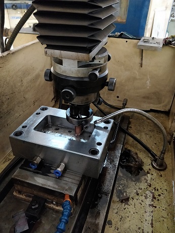 This image shows electric discharge machining process in action.